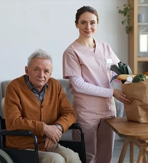 Support worker with senior man in wheelchair and groceries - Support Coordination